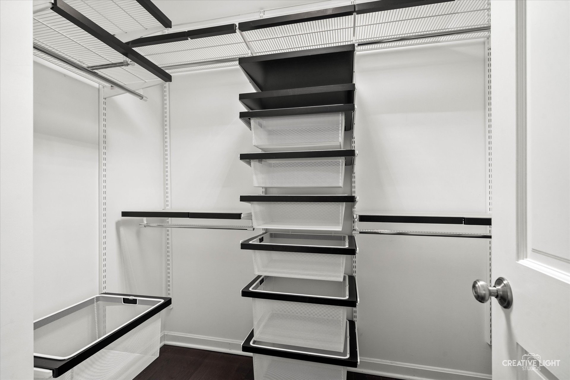 Primary walk-in closet at 1101 Barberry Court Downers Grove featuring a custom modular organization system with drawers, shelves, and hanging space.