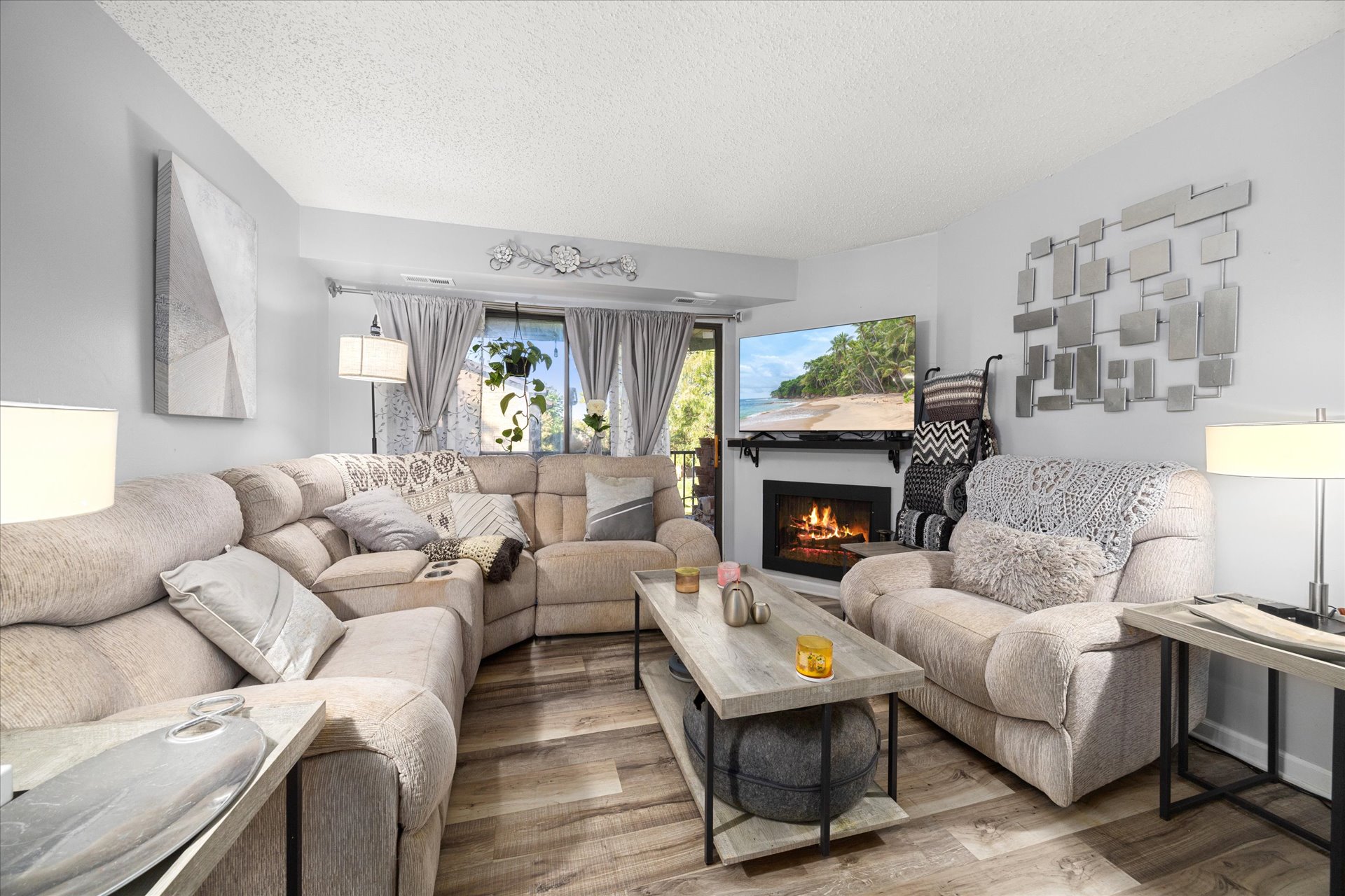 Living room with gas fireplace open to dining area at 2220 Wharf Dr Unit 1906
