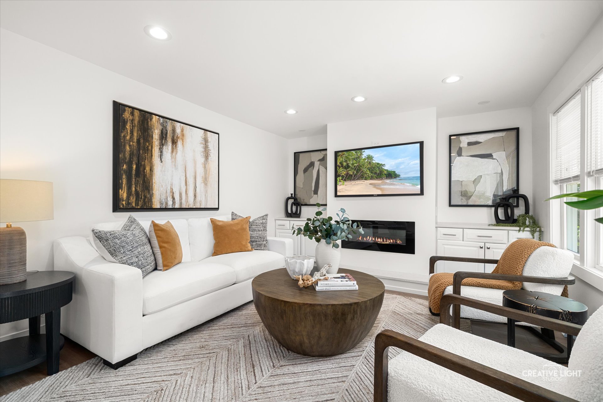 living room at 5505 Pershing Ave with built-ins flanking an electric fireplace and display niches
