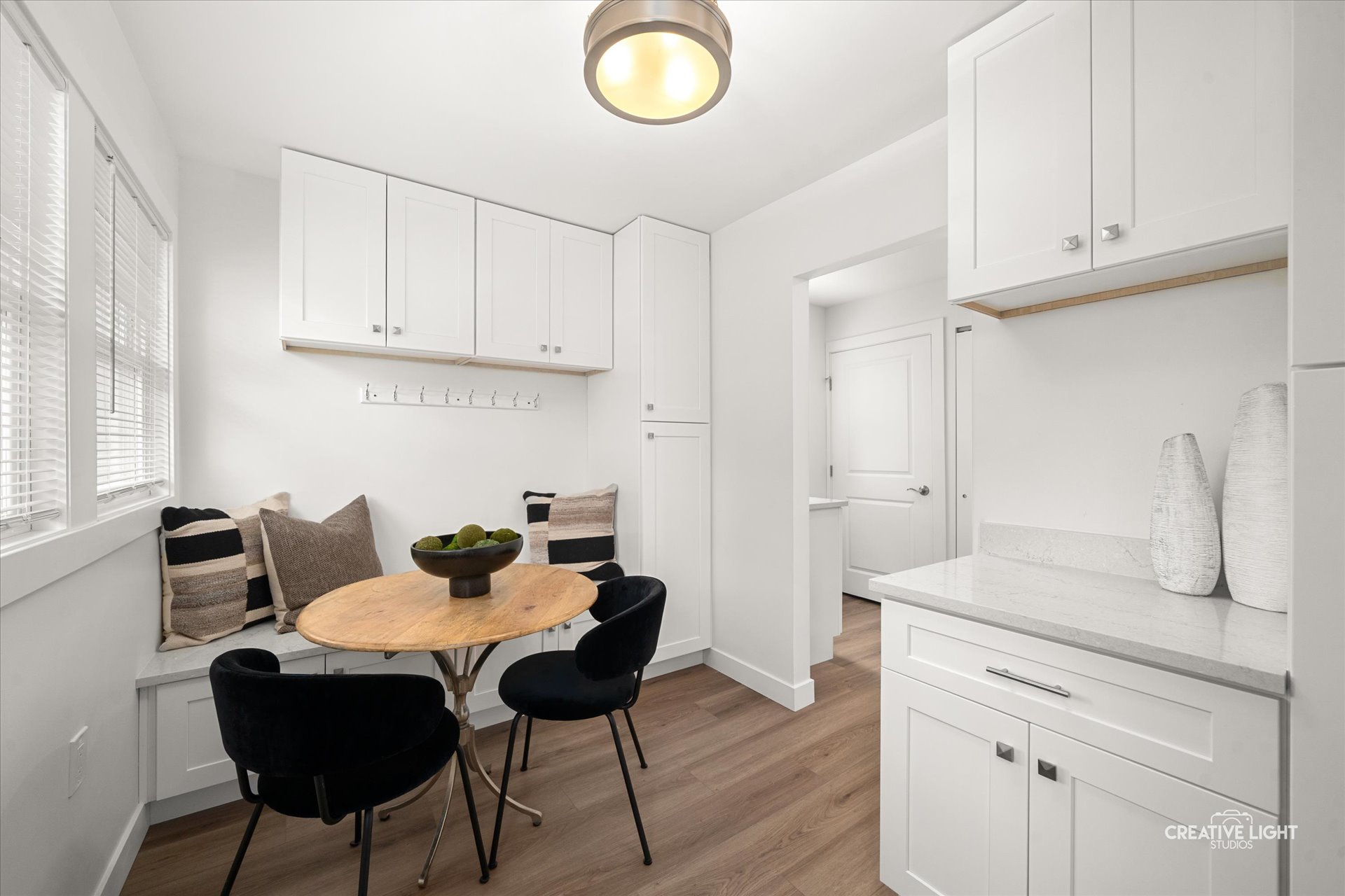 Mudroom with white cabinetry, bench, and hooks at 5505 Pershing Ave, Downers Grove
